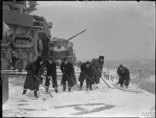 Sailors clear decks of snow